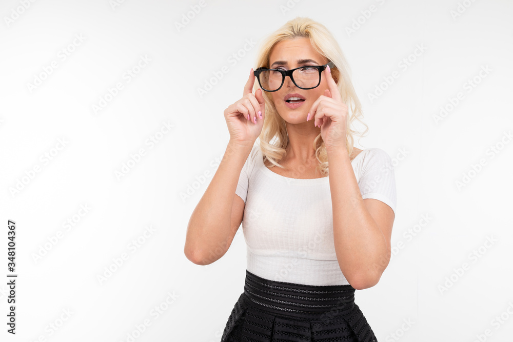 girl is uncomfortable wearing glasses for vision on a white studio background with copy space girl is uncomfortable wearing glasses for vision on a white studio background with copy space