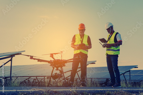 Engineer inspect and checking solar panel by Drone at solar power plant