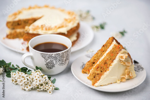 Piece of carrot cake with carrot cake on the background