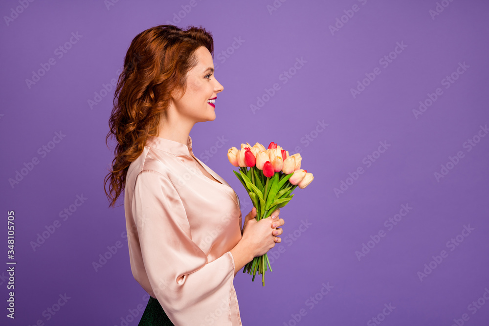 Profile photo of charming pretty lady hold bunch of fresh tulip flowers 8 march party receiving pleasant present wear luxury beige shirt blouse isolated purple color background