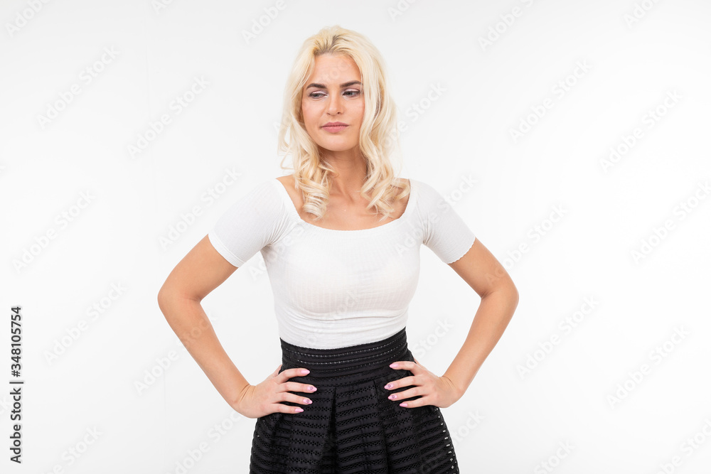 pretty blonde woman in white t-shirt posing with hands on hips on a white background pretty blonde woman in white t-shirt posing with hands on hips on a white background
