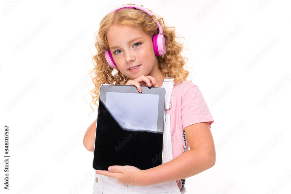 european blond girl holding a tablet in hands with the screen with mockup forward on a light blue background european blond girl holding a tablet in hands with the screen with mockup forward on a light blue background