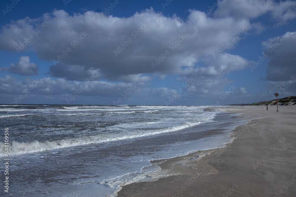 Northsea coast Netherlands. Julianadorp. Beach. Breaking waves. Clouds