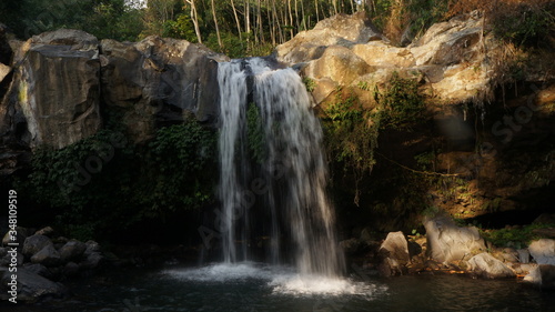 beautiful waterfall in the middle of the forest in central java, indonesia