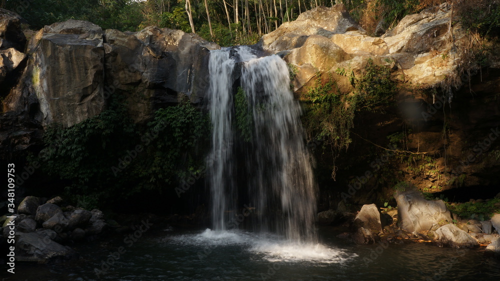 Obraz premium waterfall in the forest in central java, indonesia