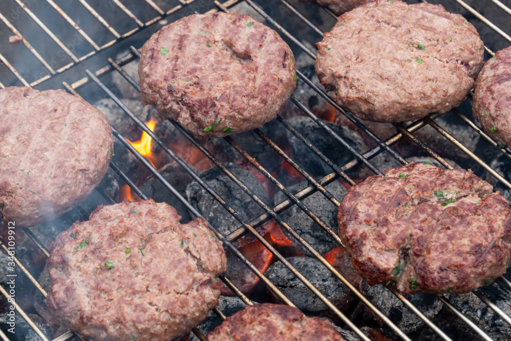 Preparing hamburgers on a grill Preparing hamburgers on a grill