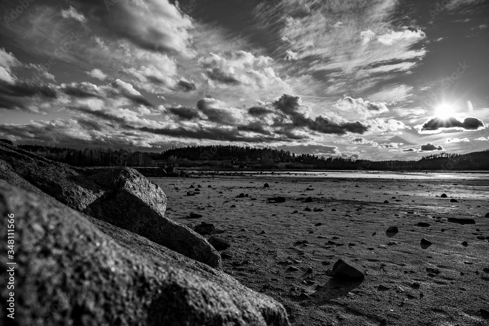 Another black and white view from empty lake with rocks on bottom
