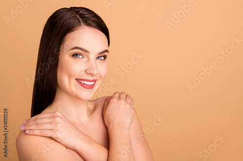 Close up photo of positive girlish lady hug herself enjoy new spa salon treatment to make skin pure perfect ideal isolated over pastel color background