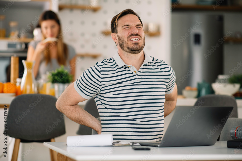 Young man working on lap top. Handsome man working at home. Young man working on lap top. Handsome man working at home.