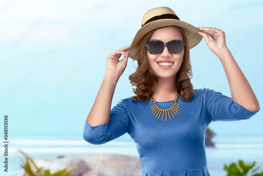 Asian woman with hat and sunglasses traveling to the beach
