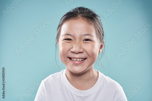 Cute Asian little girl with happy charming smile.