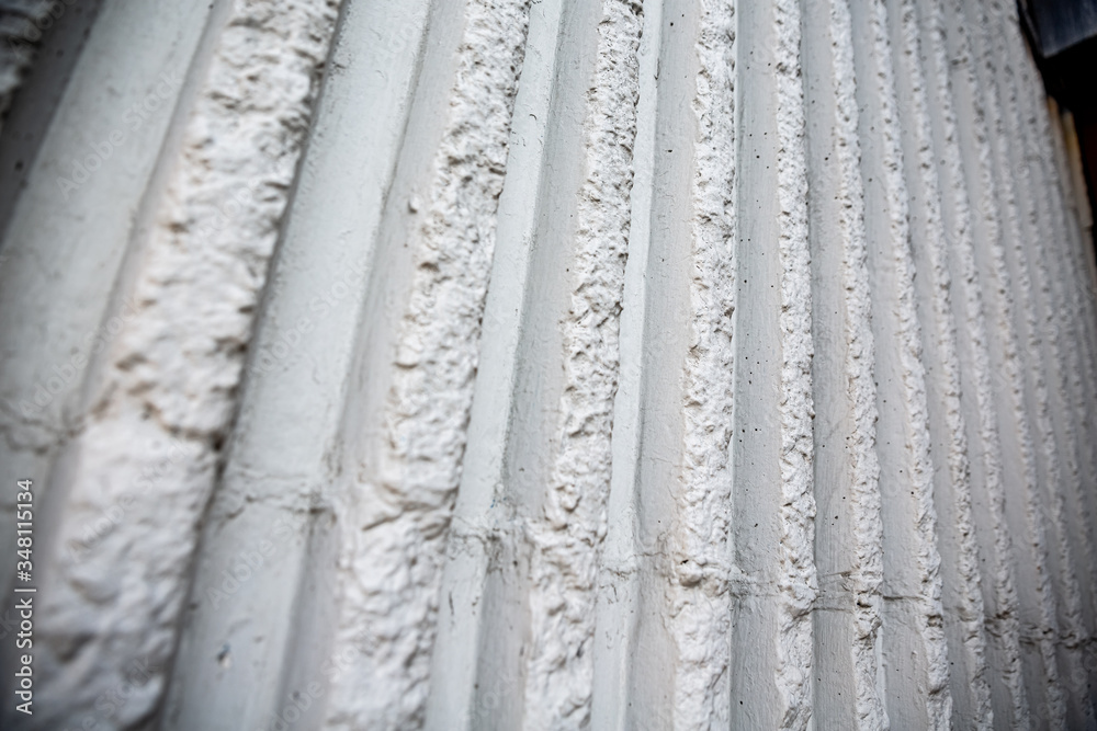 Fototapeta premium white ruined stone wall vertical