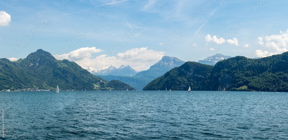 panoramic view into the mountains on a boat cruise on lake lucerne end of spring