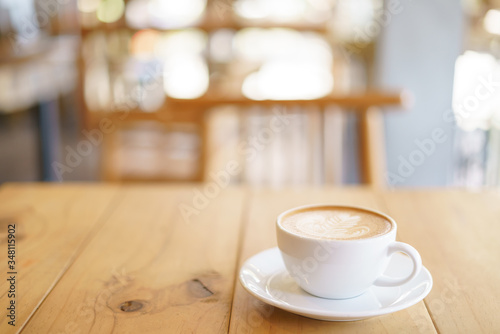 Cup of coffee with fern tree pattern milk foam