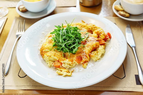 omelet with cherry tomatoes and arugula