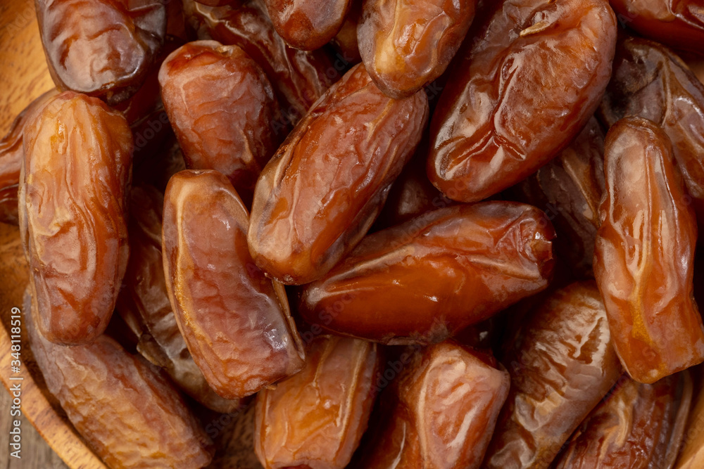 Close up of cluster dates plam. Fresh dates plam on wooden table.