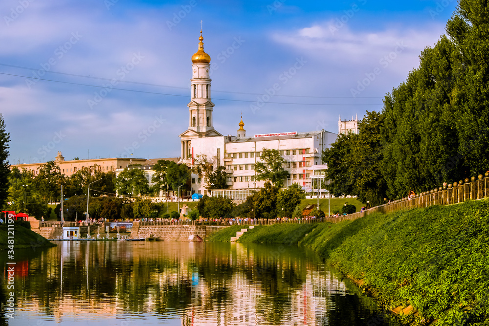 Ukraine. The city of Kharkov. City buildings are reflected in the river.