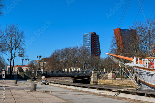 View of Birzos or Exchange bridge over river Dane in Klaipeda, Lithuania with a moored sailing ship