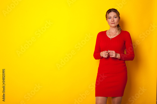Bilde på lerret woman forty years in a dress on a yellow background