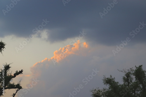 rain clouds with blue sky and sunrise background theme