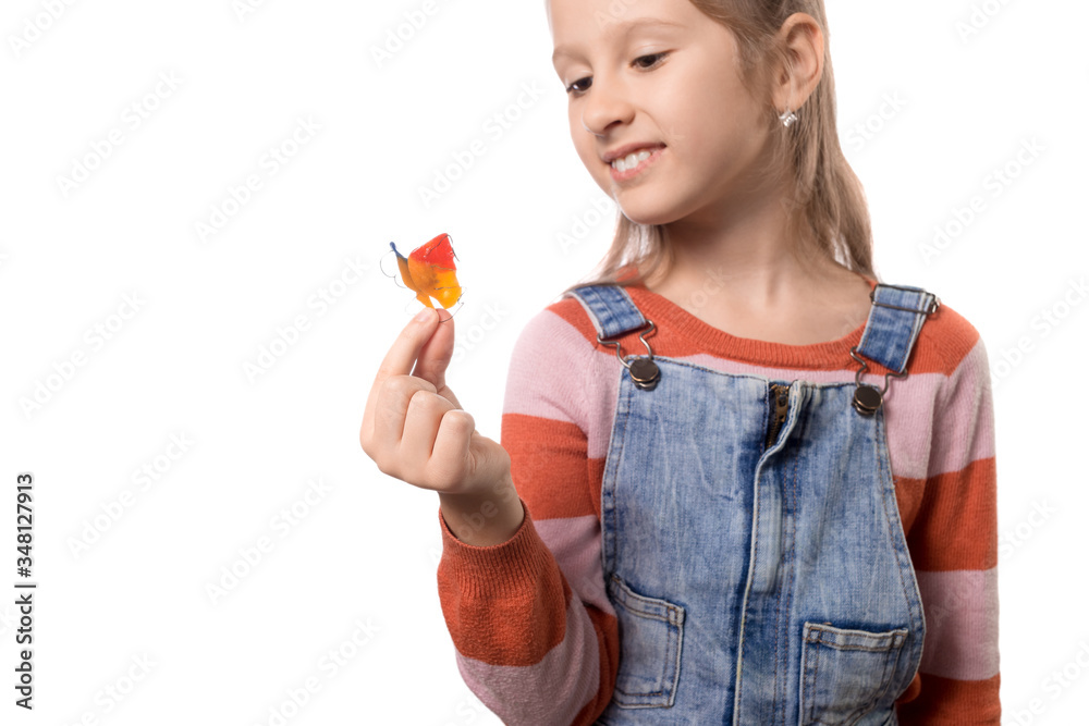 Little girl with orthodontics appliance isolated on white background. Little girl with orthodontics appliance isolated on white background.