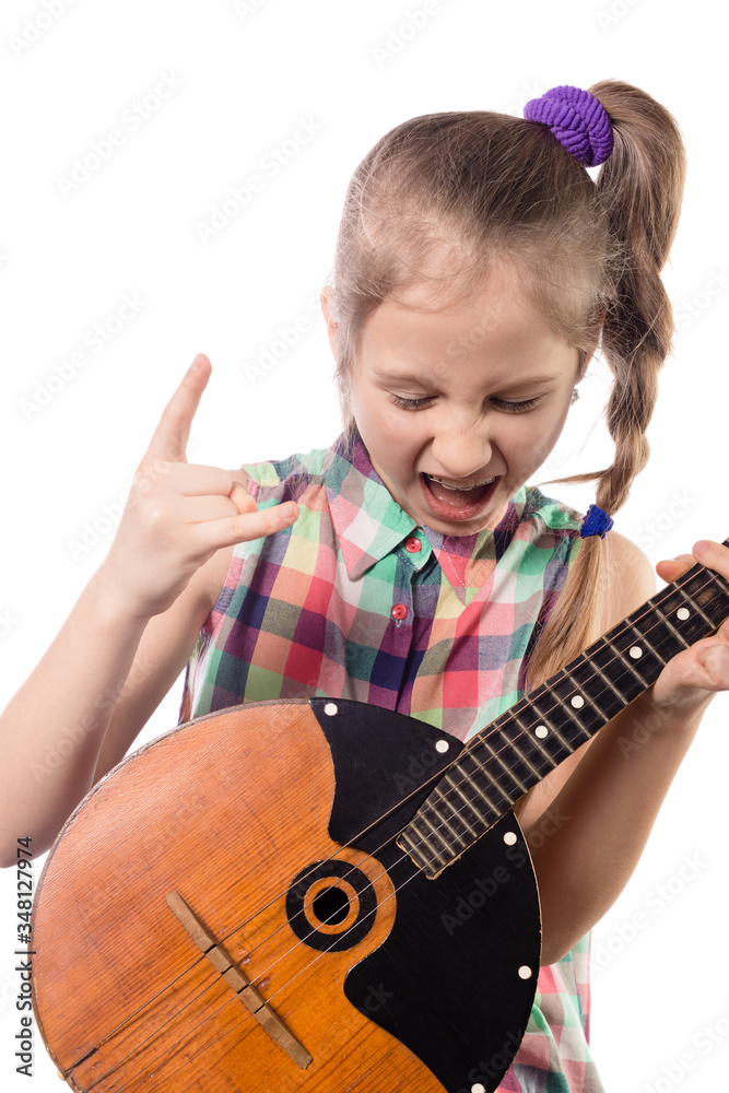 Cute little girl playing on domra. Studio photo. Cute little girl playing on domra. Studio photo.