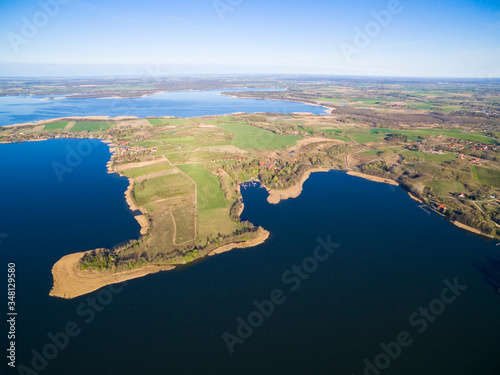 Aerial view of beautiful Kal village (former Kehlen or Kielno, East Prussia) located on Swiecajty Lake shore, Mazury, Poland photo