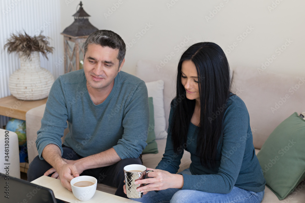 Couple at home drinking coffee in the living room Couple at home drinking coffee in the living room
