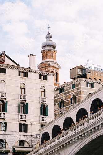 The beautiful Ponte di Rialto Bridge over the Central Grand Canal in Venice  Italy  with shops  beautiful views and lots of people. Near boat station of the same name  the street leads to San Marco