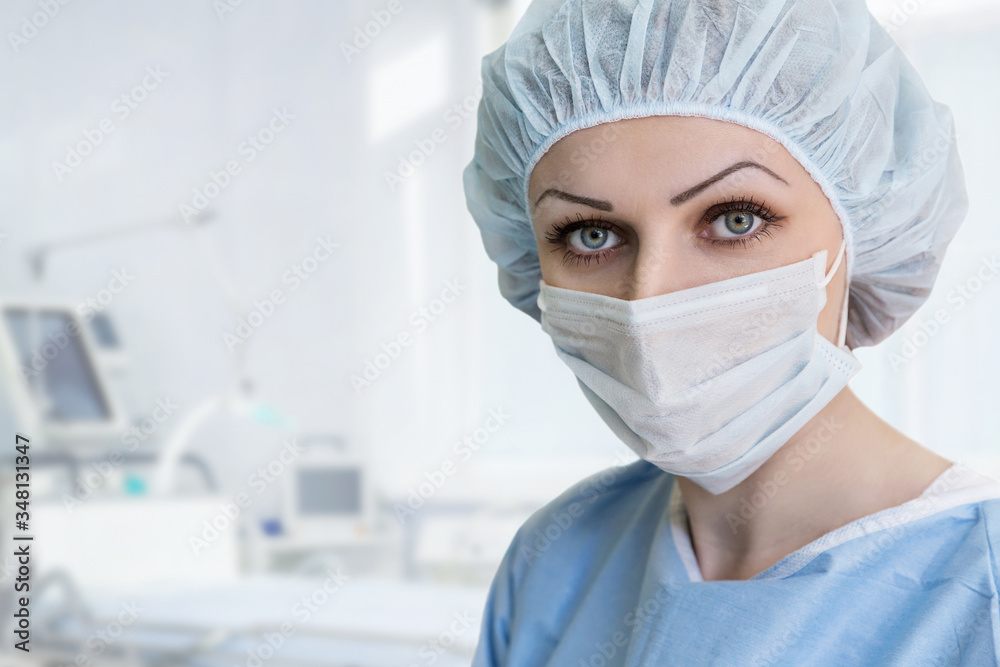 Portrait of nurse in protective mask and cap, looking at camera. Eyes close-up. Health care, surgery. Portrait of nurse in protective mask and cap, looking at camera. Eyes close-up. Health care, surgery.