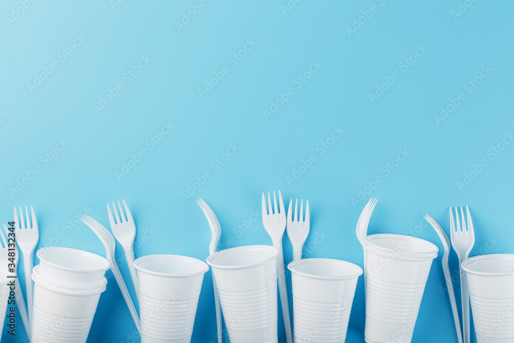 Dishes made of white plastic on a blue background. Dishes made of white plastic on a blue background.