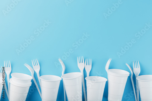 Dishes made of white plastic on a blue background.