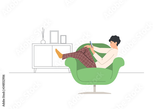 Man at home in chair with smartphone