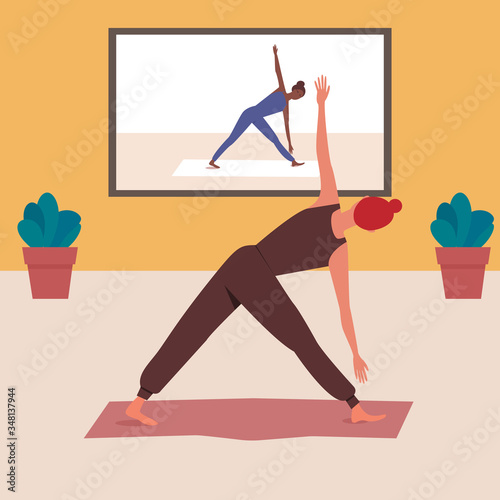 Woman doing yoga at home. Yoga online during the coronavirus pandemic.