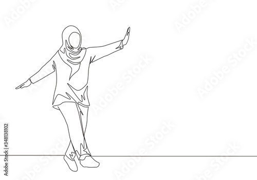 One continuous line drawing of young beautiful happy muslimah with headscarf dance on street road. Beauty Asian woman model in trendy hijab fashion concept single line draw design vector illustration