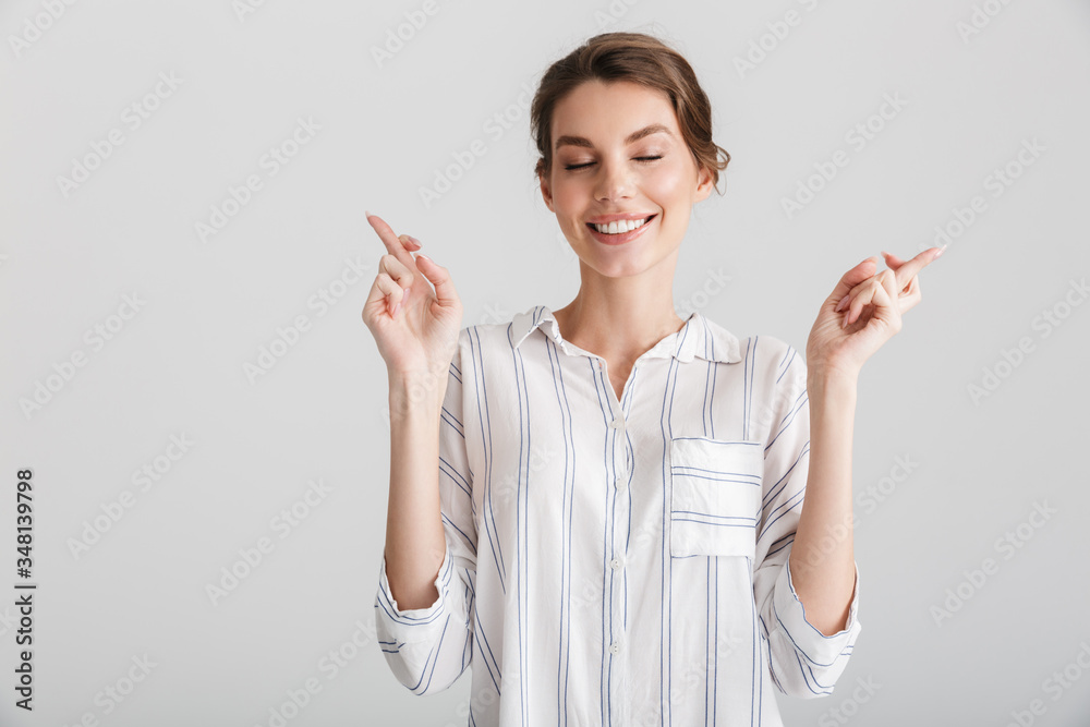 Image of excited caucasian woman holding fingers crossed for good luck Image of excited caucasian woman holding fingers crossed for good luck