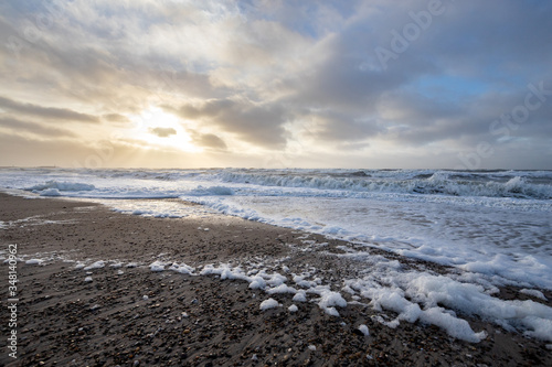 beach at sunset with sea foam