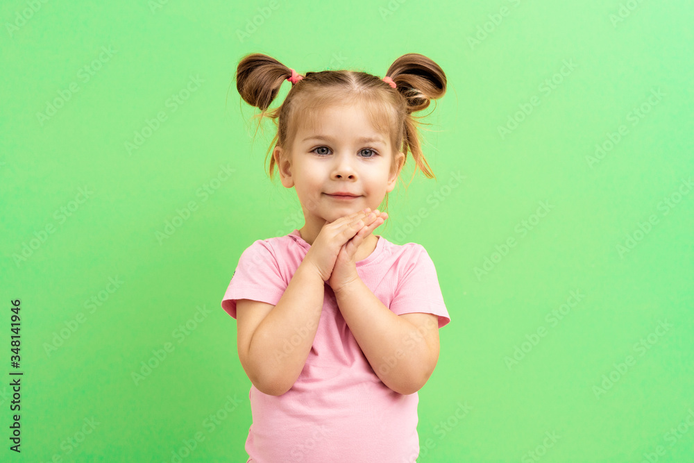 little girl 4 years old in a pink T-shirt on a green background little girl 4 years old in a pink T-shirt on a green background