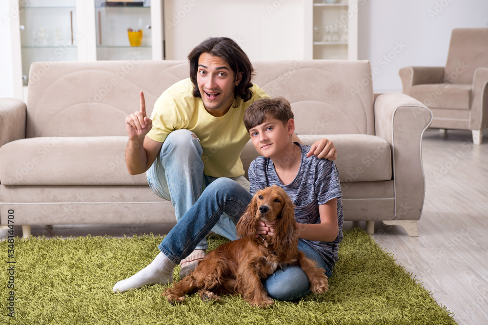 Young father and his son with cocker spaniel dog Young father and his son with cocker spaniel dog