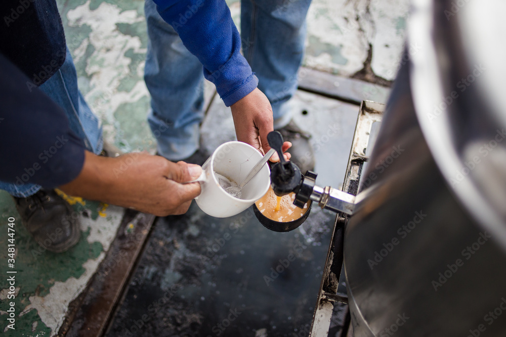 Close up image of factory workers making coffee at the coffee station Close up image of factory workers making coffee at the coffee station