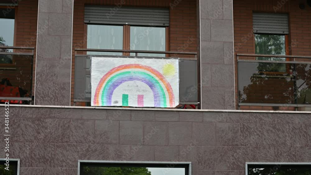 Turin,Piedmont,Italy. May 2020. Coronavirus pandemic. On the facades of the houses hang the sheets with the drawing of the rainbow and the message everything will be fine,in italian 
