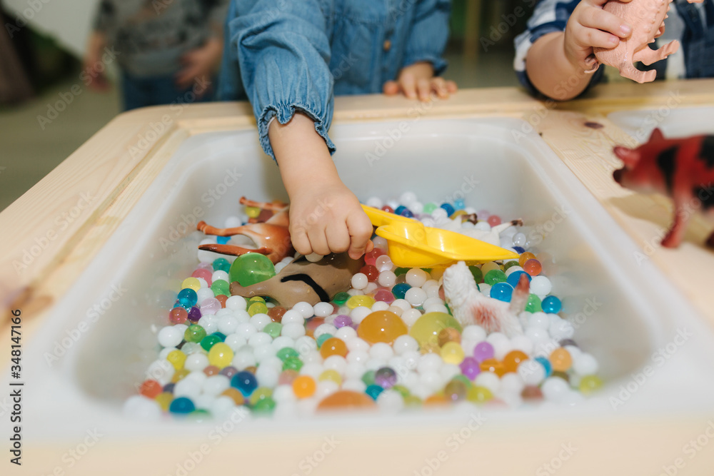 Close-up of kids take orbeez from water Close-up of kids take orbeez from water