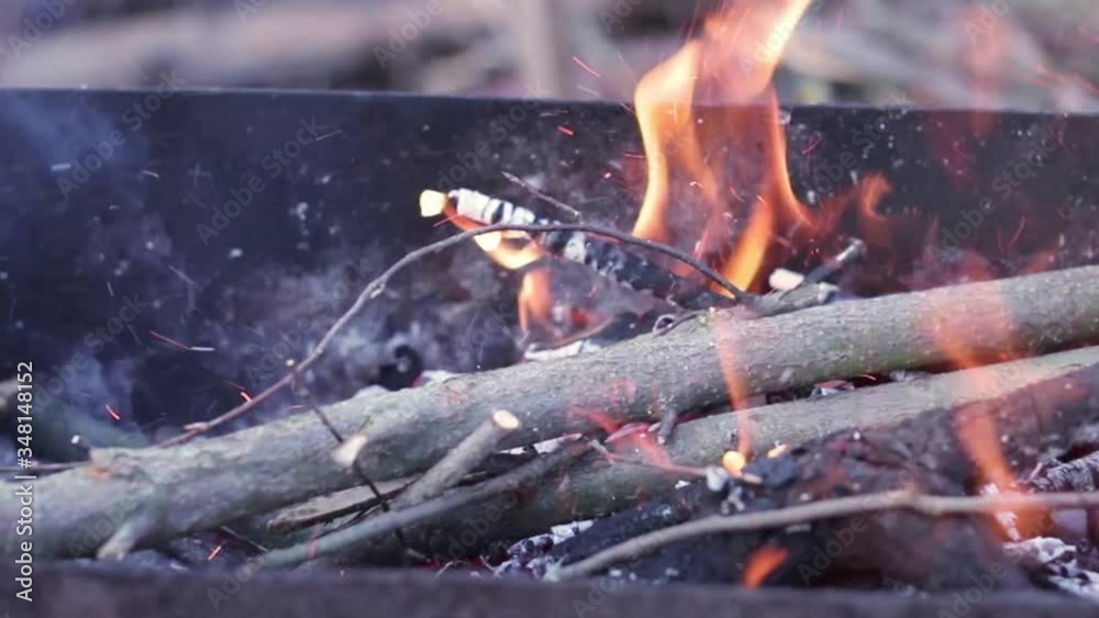 Close up view of glowing flying fire flame from hot bonfire charcoal. Close up view of glowing flying fire flame from hot bonfire charcoal.