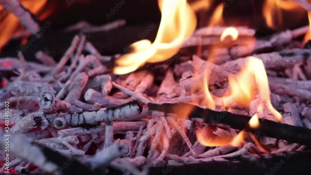 Close up view of glowing flying fire flame from hot bonfire charcoal. Close up view of glowing flying fire flame from hot bonfire charcoal.