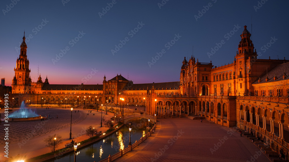 Seville, Spain - February 20th, 2020 - Blue Hour of the beautiful pavilion buildings within the Plaza de España / Spain Square in Seville City Center.