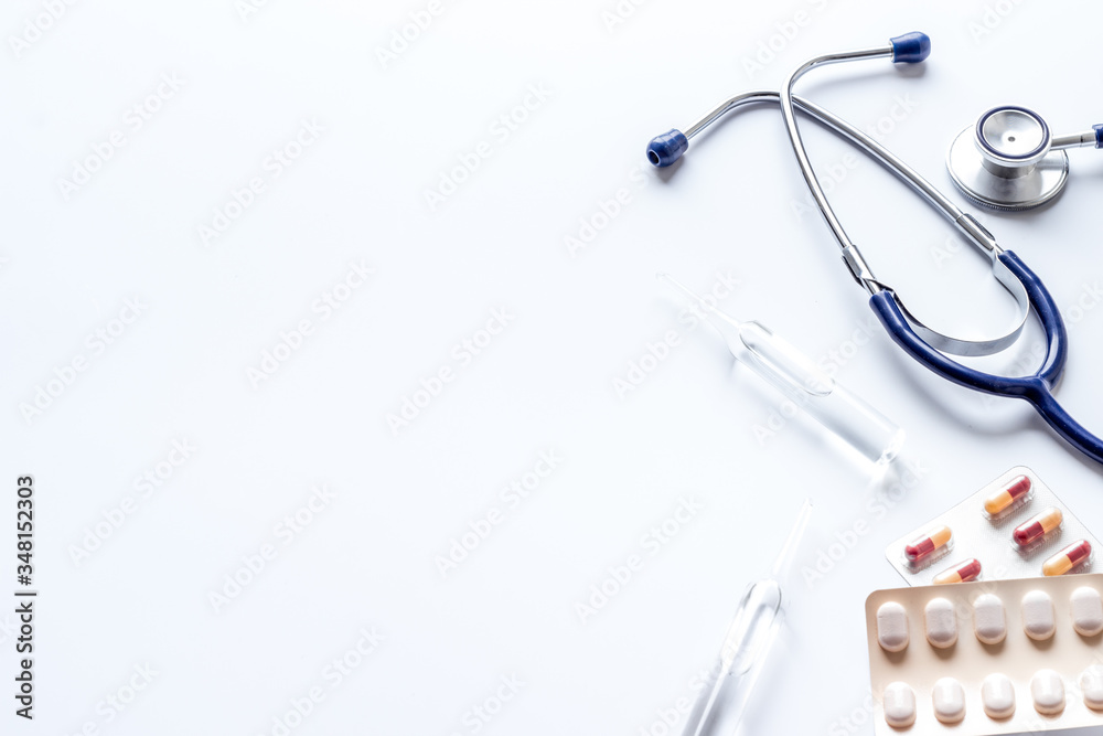 Treatment of influenza or cold. Medicine, stethoscope on white table copy space Treatment of influenza or cold. Medicine, stethoscope on white table copy space