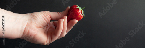 Red ripe strawberries in hand