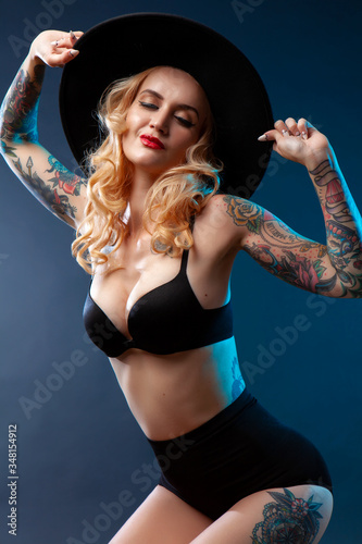 Beautiful girl with stylish make-up and tattooed arms.