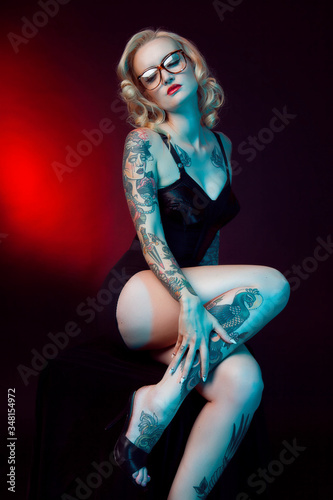 Beautiful girl with stylish make-up and tattooed arms