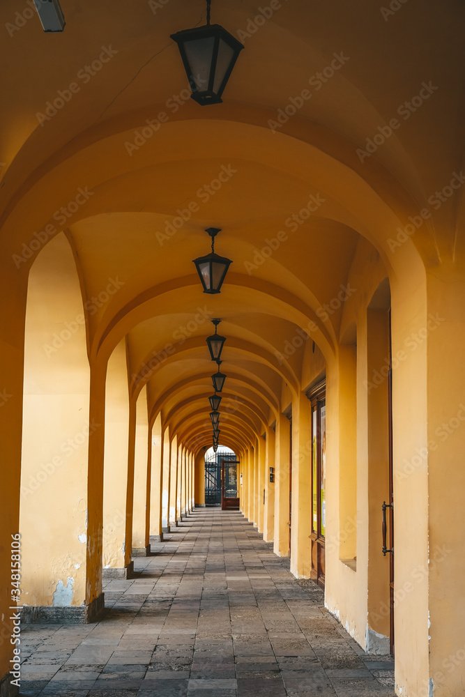 A beautiful yellow building with multiple arches and lanterns